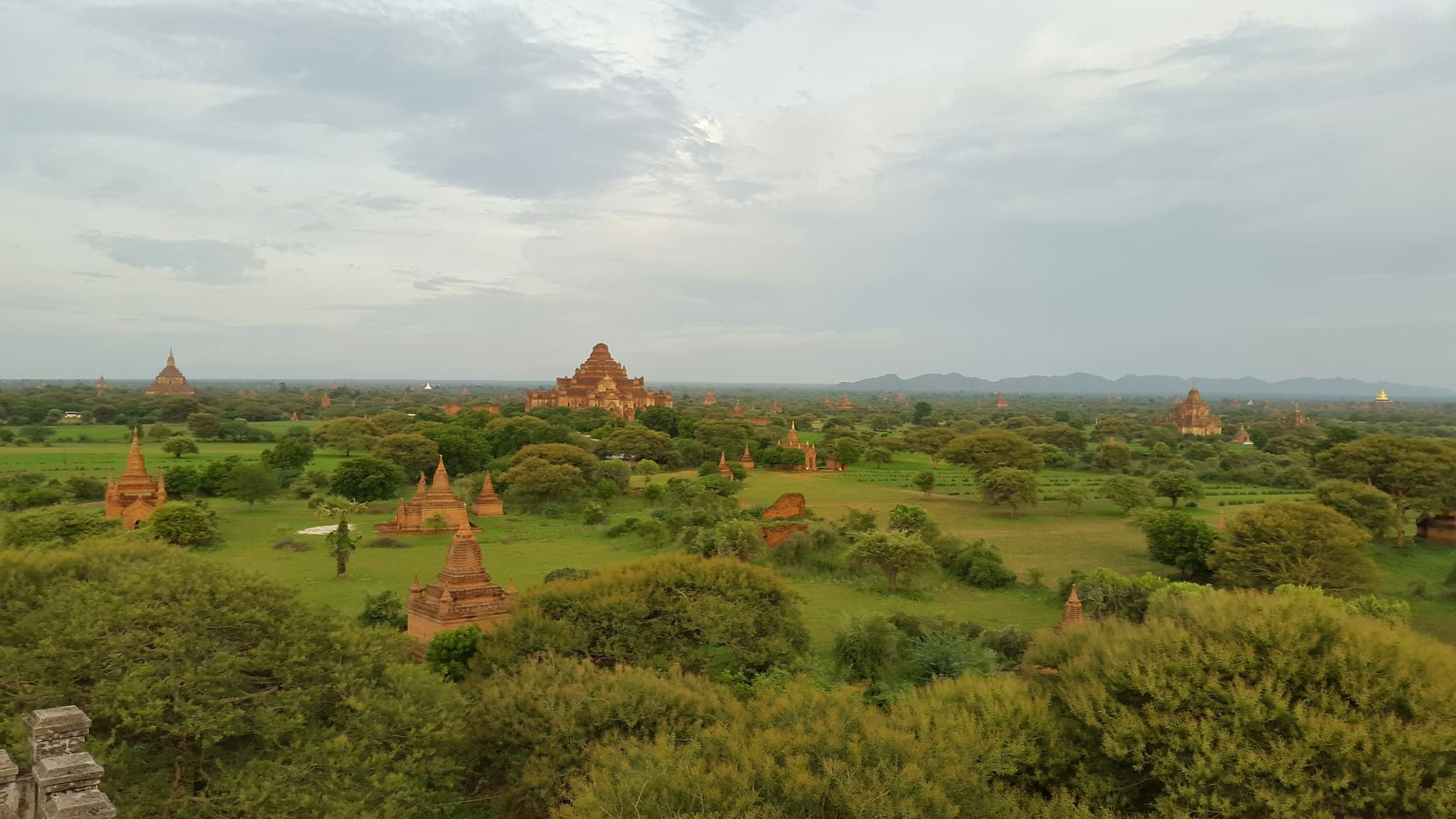 Northeast Thailand Isaan landscape with ancient Khmer temple ruins and rice fields