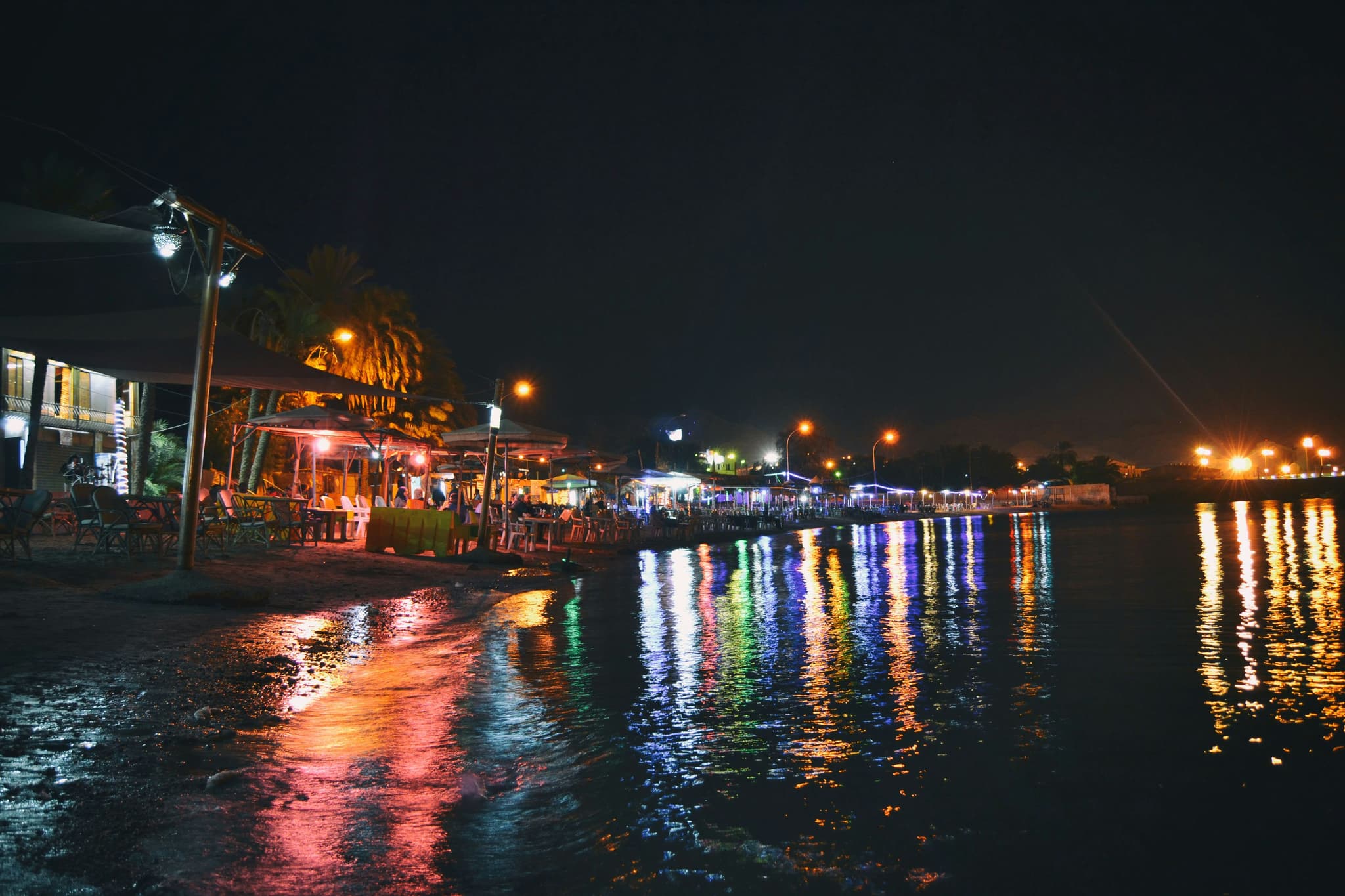 Pattaya beachfront at night with colorful lights and vibrant entertainment district