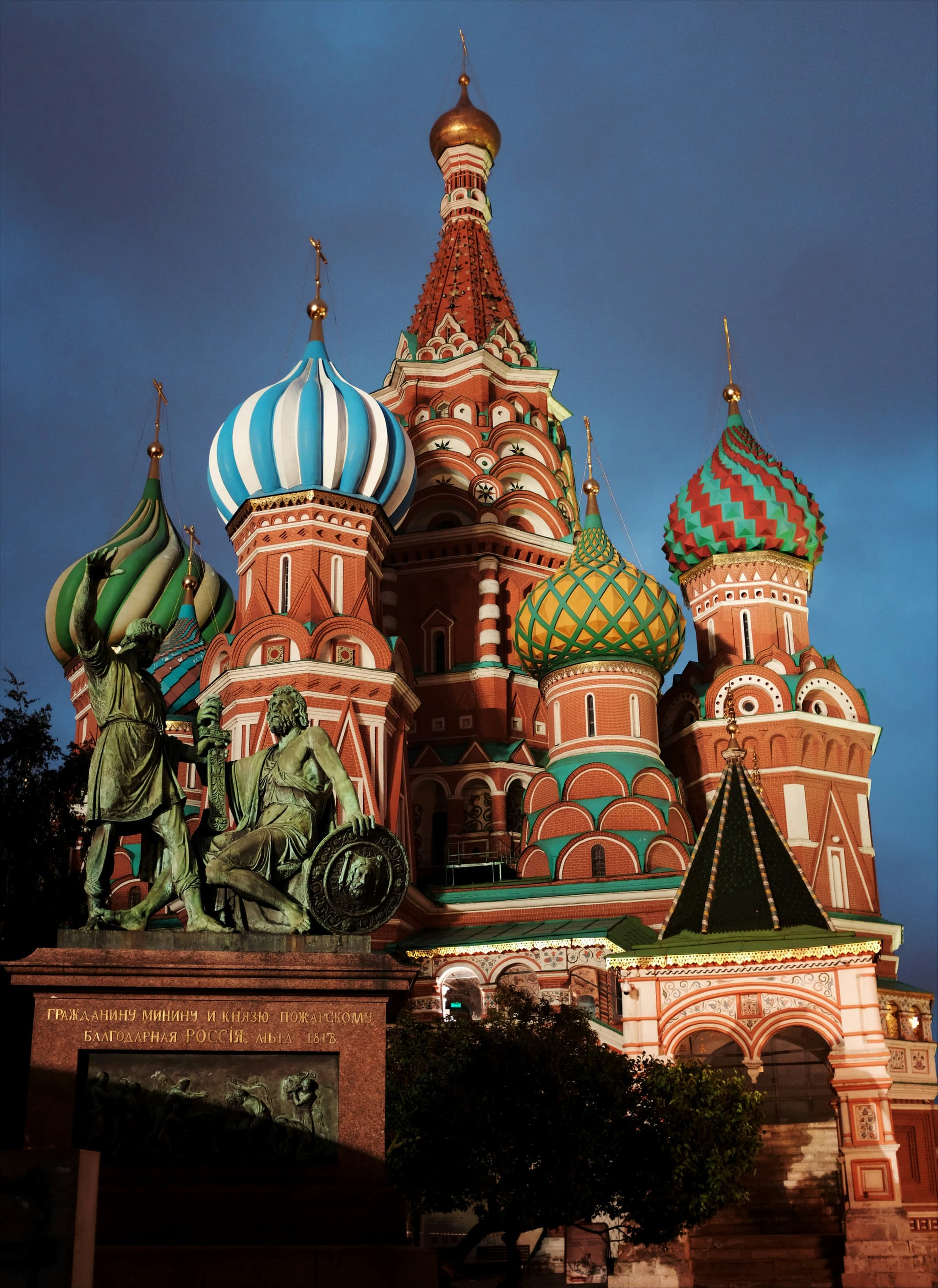Moscow Red Square with Saint Basil Cathedral colourful onion domes and Kremlin walls at dusk