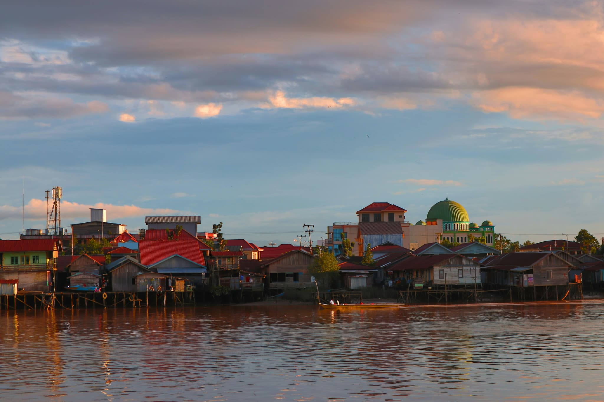 Chiang Khan riverside town on the Mekong River with traditional wooden houses and golden sunset