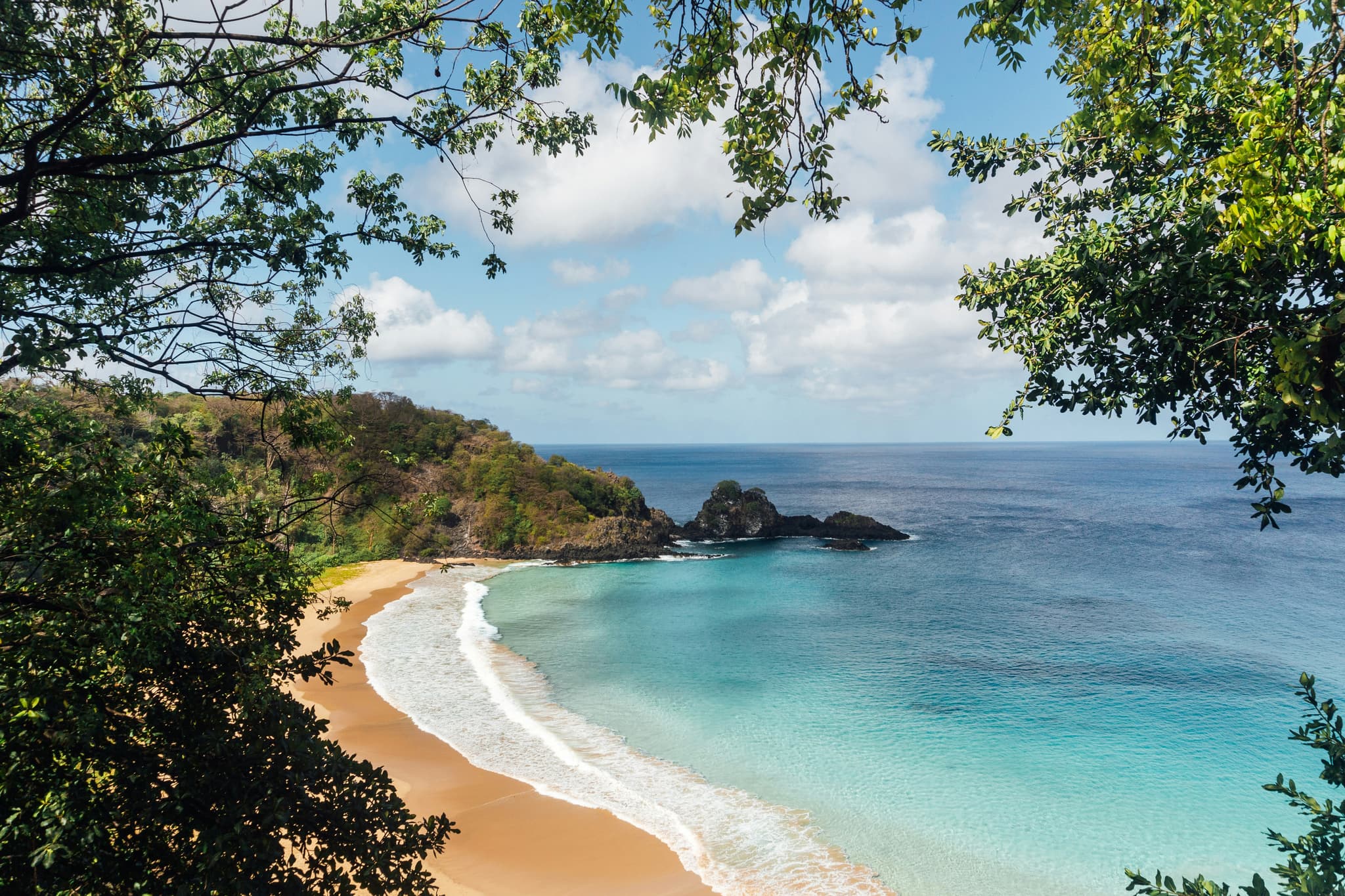 Khao Lak pristine beach with calm turquoise waters and lush tropical jungle