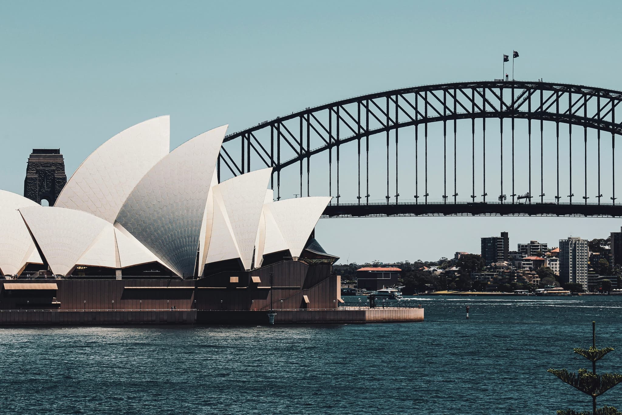Sydney Opera House and Harbour Bridge with stunning blue harbour waters and city skyline
