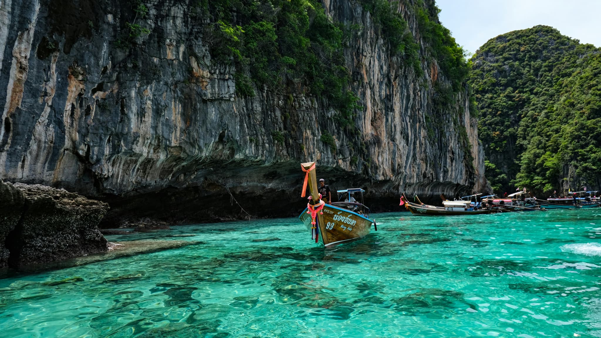 Pristine Thai beach with turquoise water and limestone cliffs
