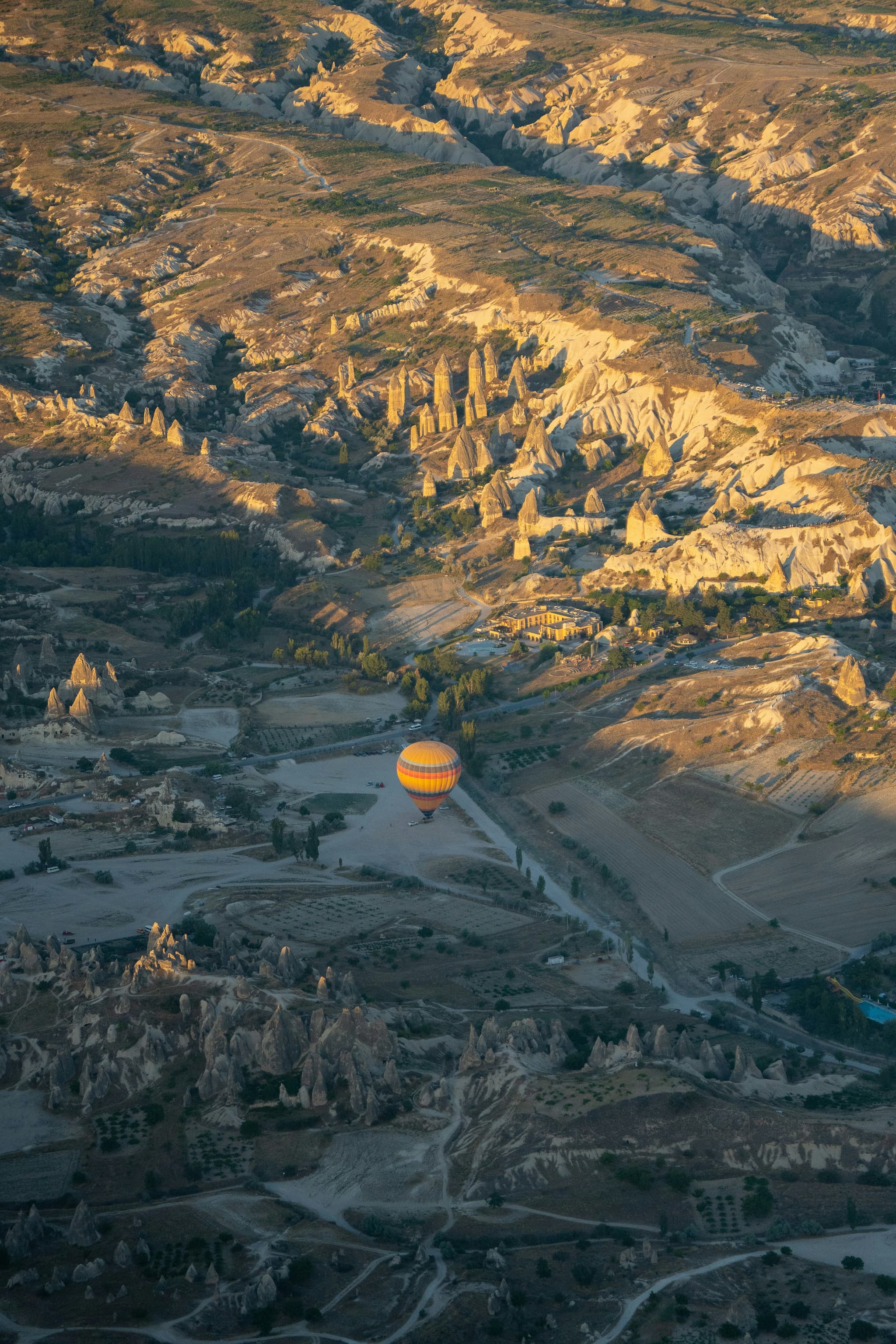 Cappadocia Turkey hot air balloons floating over fairy chimney rock formations at sunrise