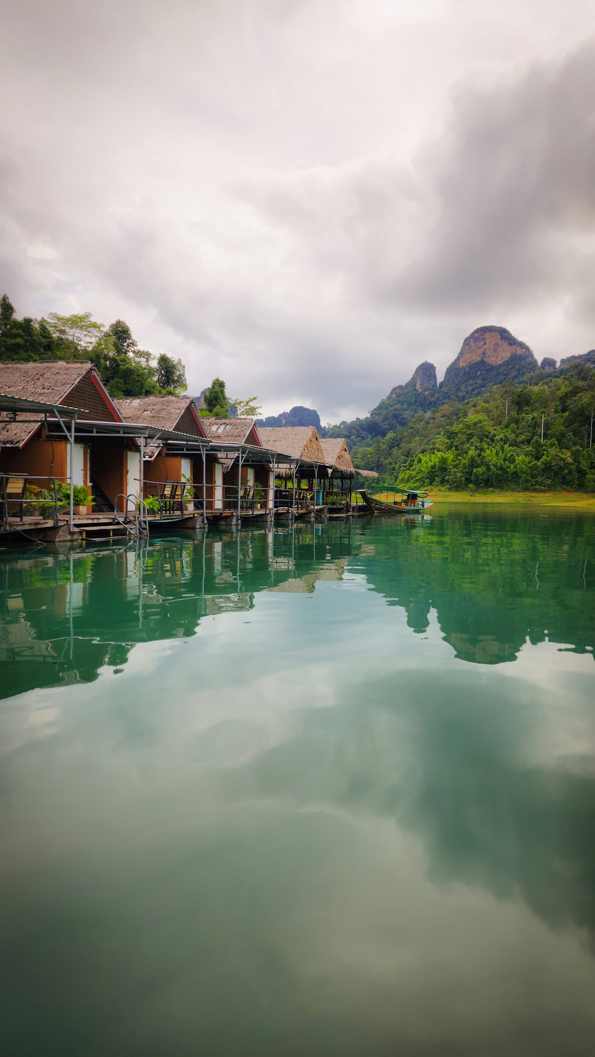 Floating bungalows on Cheow Lan Lake surrounded by ancient rainforest and limestone peaks