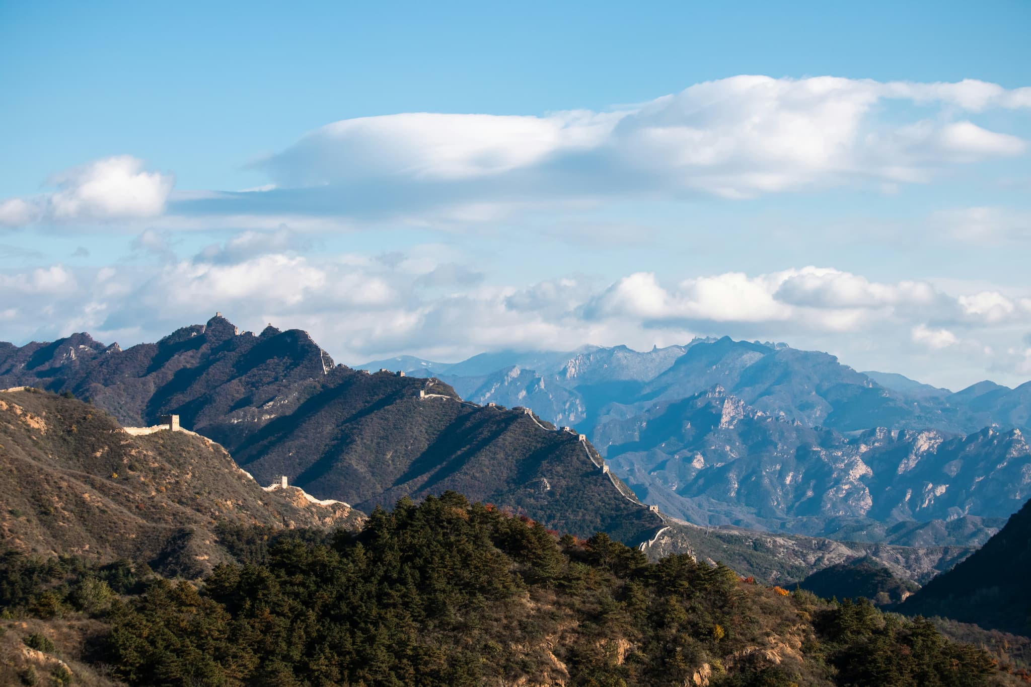 Great Wall of China stretching across misty mountain ridges at sunrise