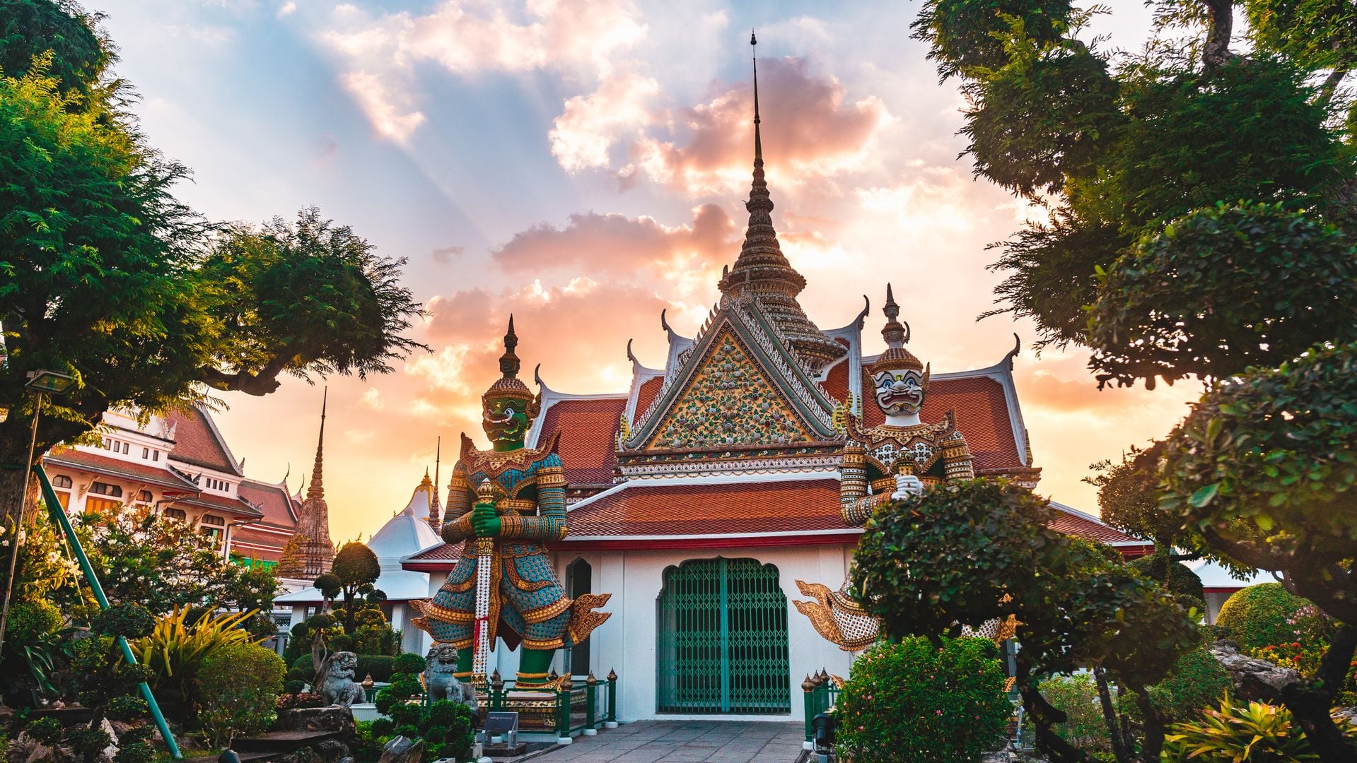 Wat Arun temple at sunset reflecting on the Chao Phraya River — Golden Rise Travels Thailand destinations